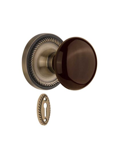 Rope Rosette Mortise-Lock Set with Brown Porcelain Knobs in Antique Brass.